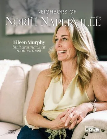 Magazine cover: a woman smiling in a cream armchair, leaning forward on folded hands, under the masthead.