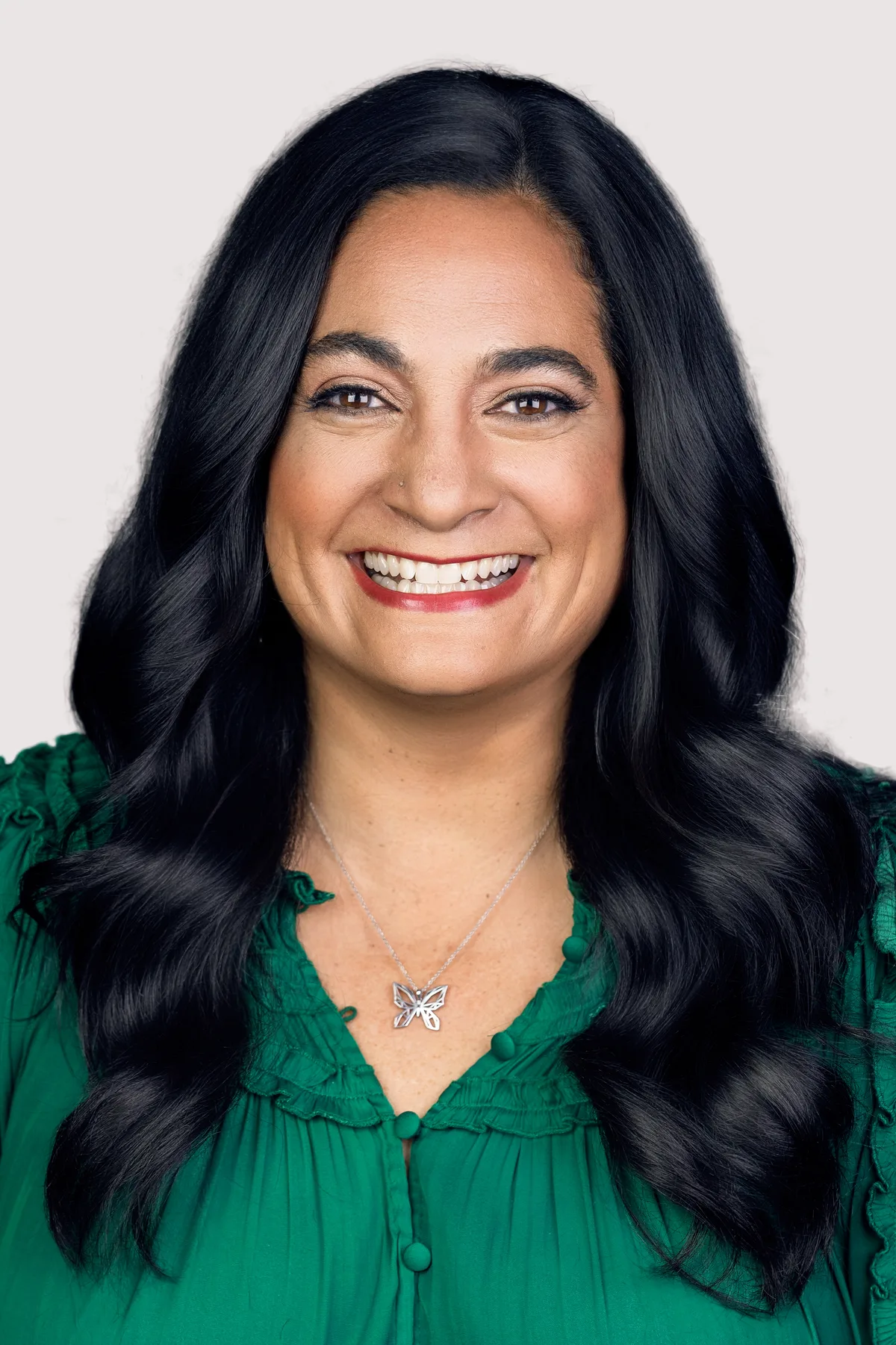 A headshot made on a clean light backdrop brought into the office, even light across the face.
