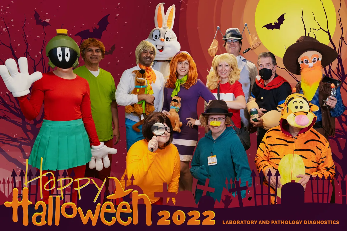 The physicians dressed as cartoon characters, composited into a Halloween graveyard under a full moon.
