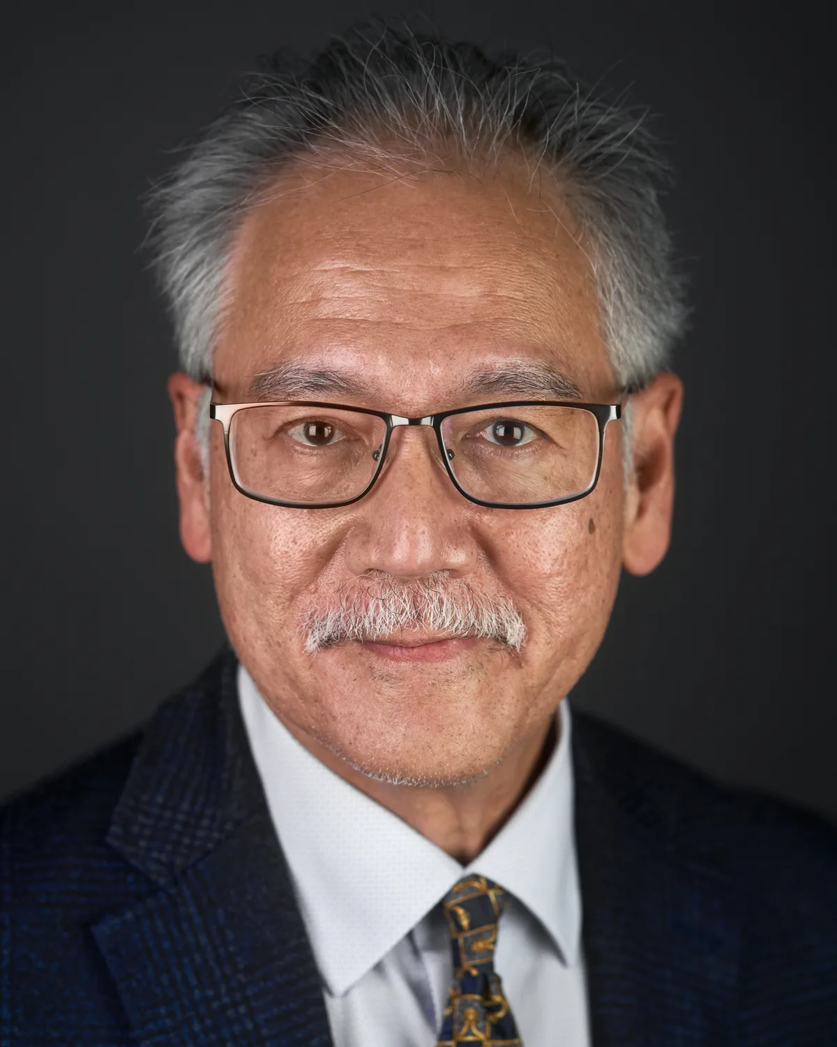 A third headshot from the same team, matched to the others frame for frame.