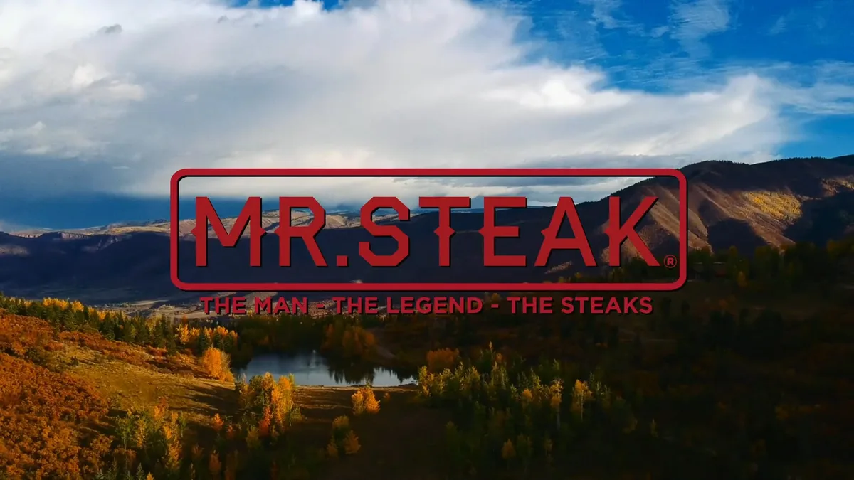Title frame of the Aspen spot: the red Mr. Steak wordmark over an autumn mountain valley.